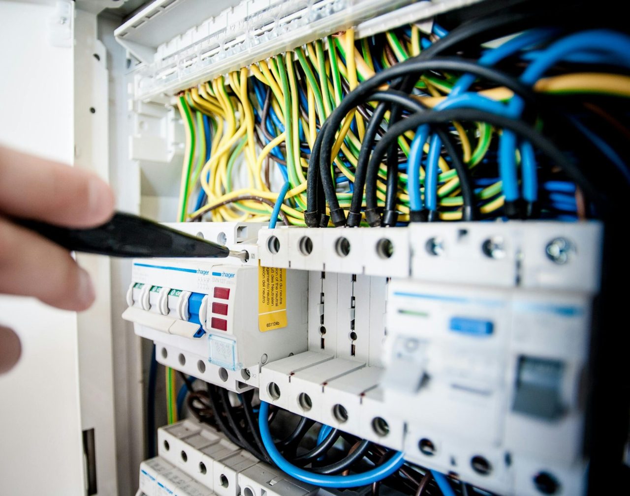 Electrician Fixing an Opened Switchboard